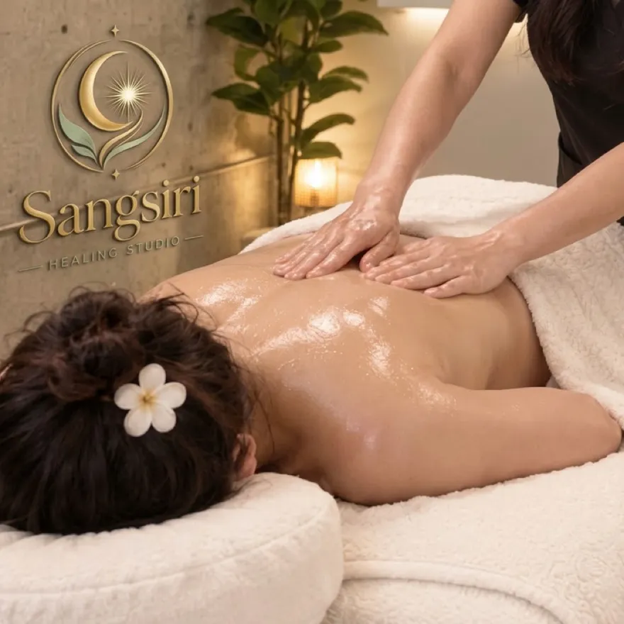 Long gliding strokes with oil across a client's back during a Swedish massage